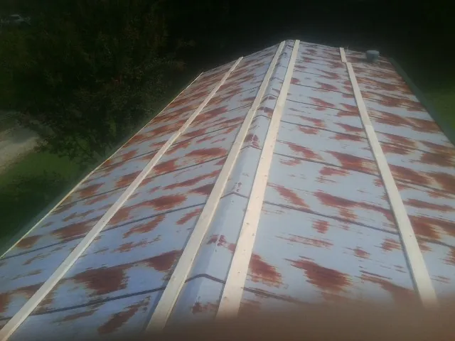 Rusted metal roof panels with new wood purlins before replacement — Storm Damage Roof Repair in South Bend by Roofing Brothers